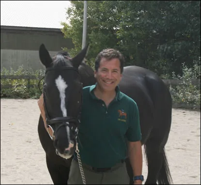Dr. Bruce Indek standing with a black horse